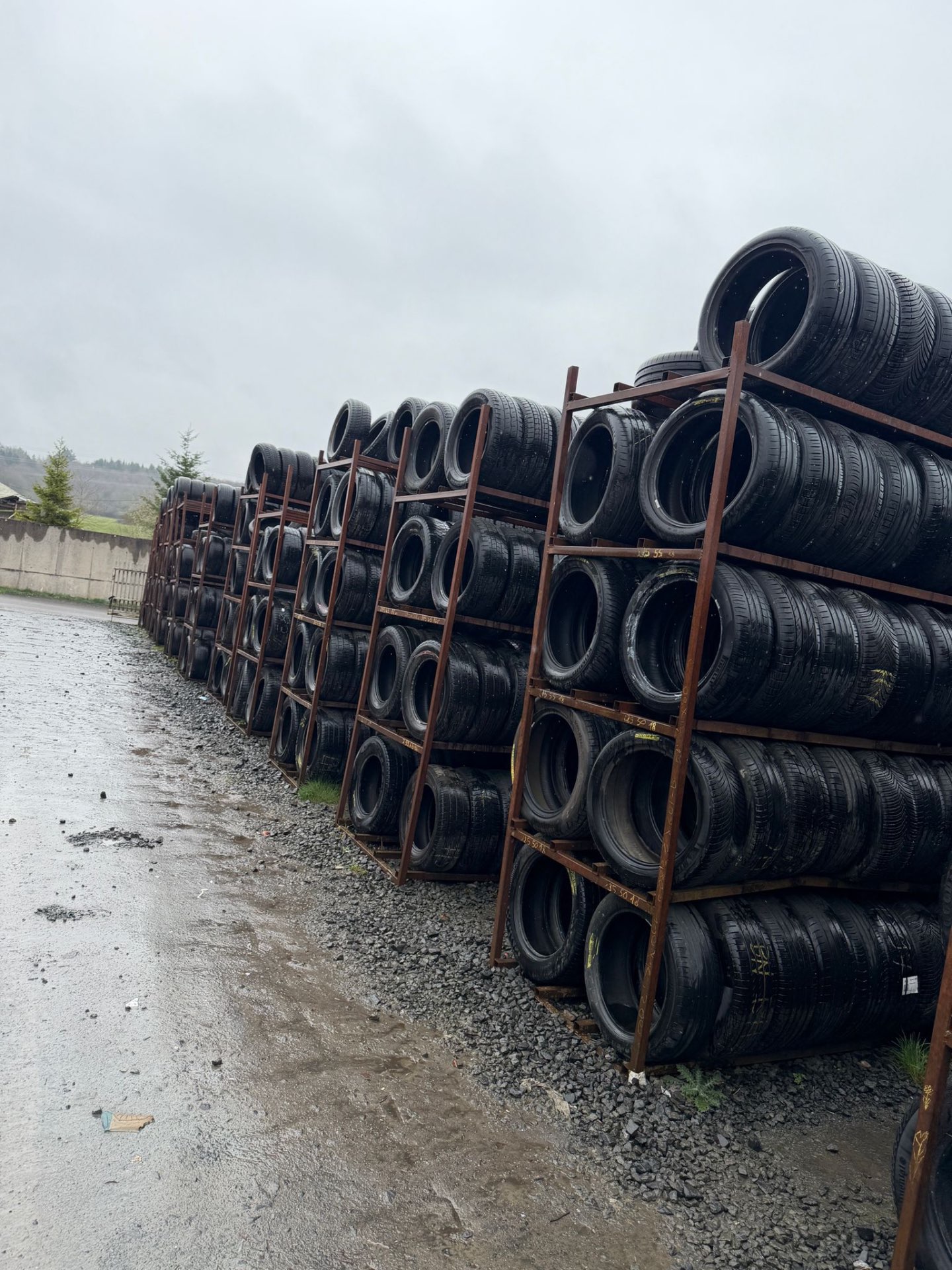 Rows of used tyres stored on racks at the A2Z Tyre Recycling yard