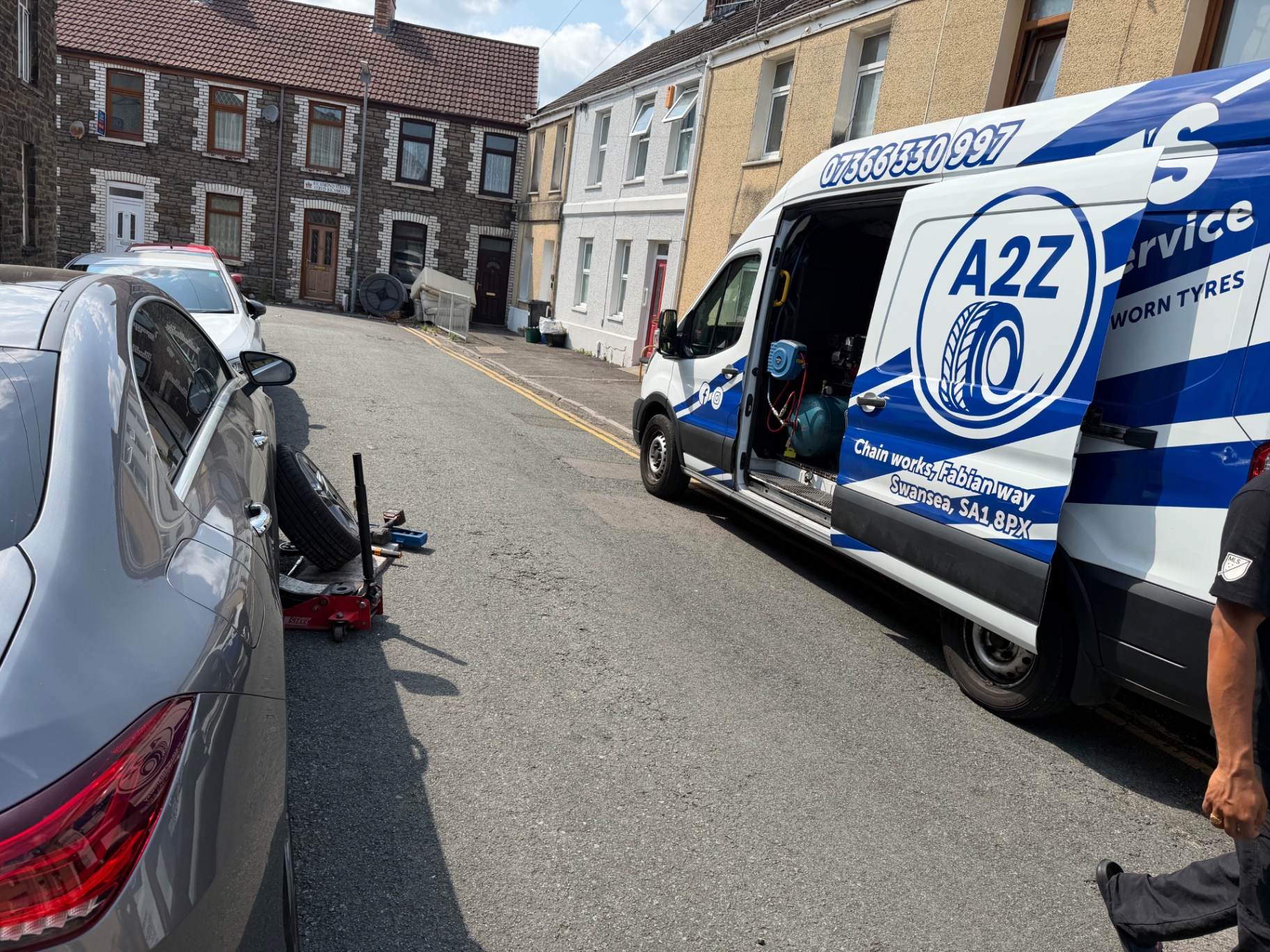 A2Z Mobile Tyre Service van working on a car on a residential street in Swansea